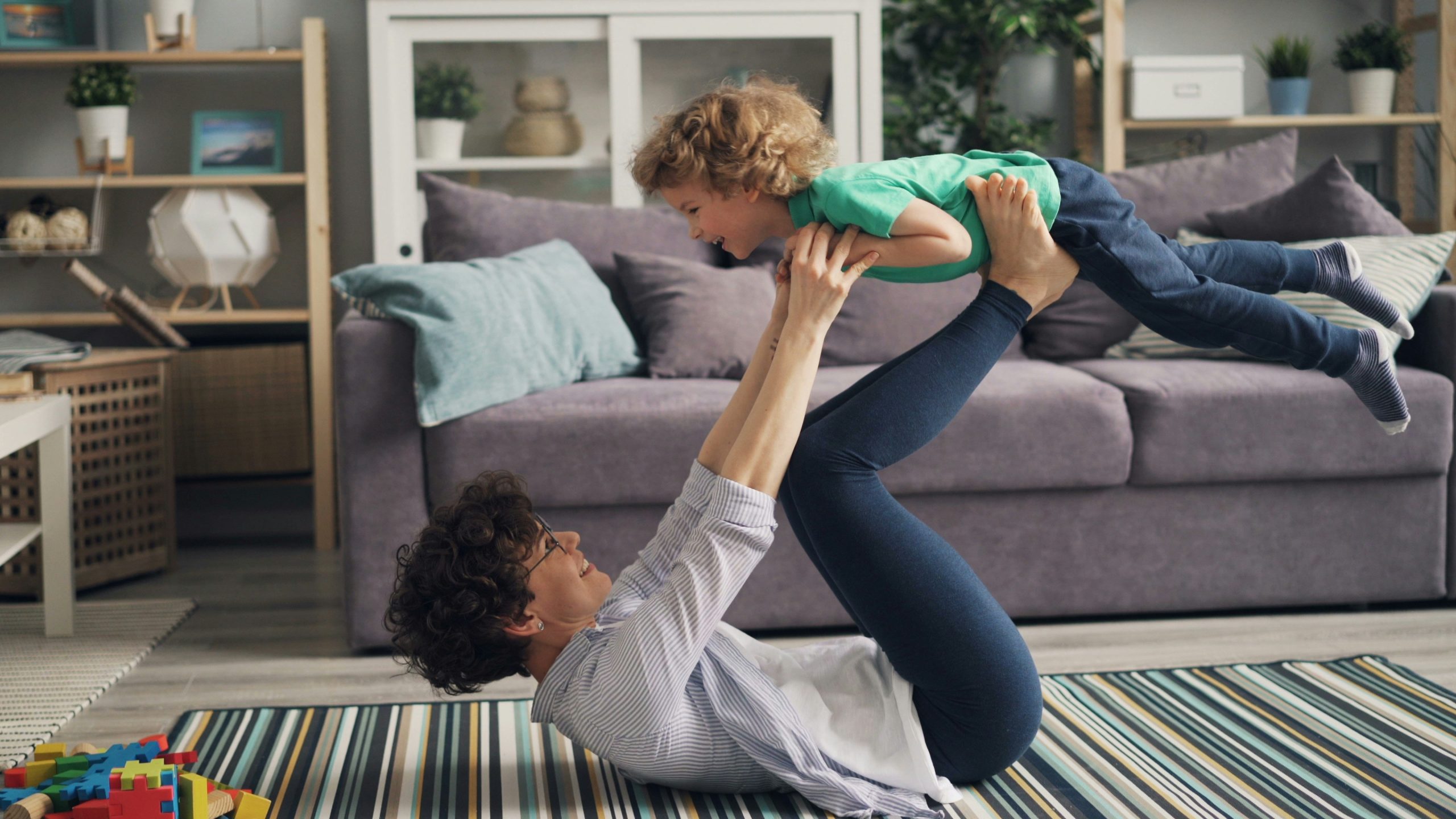 Parent and child keeping active together through play at home